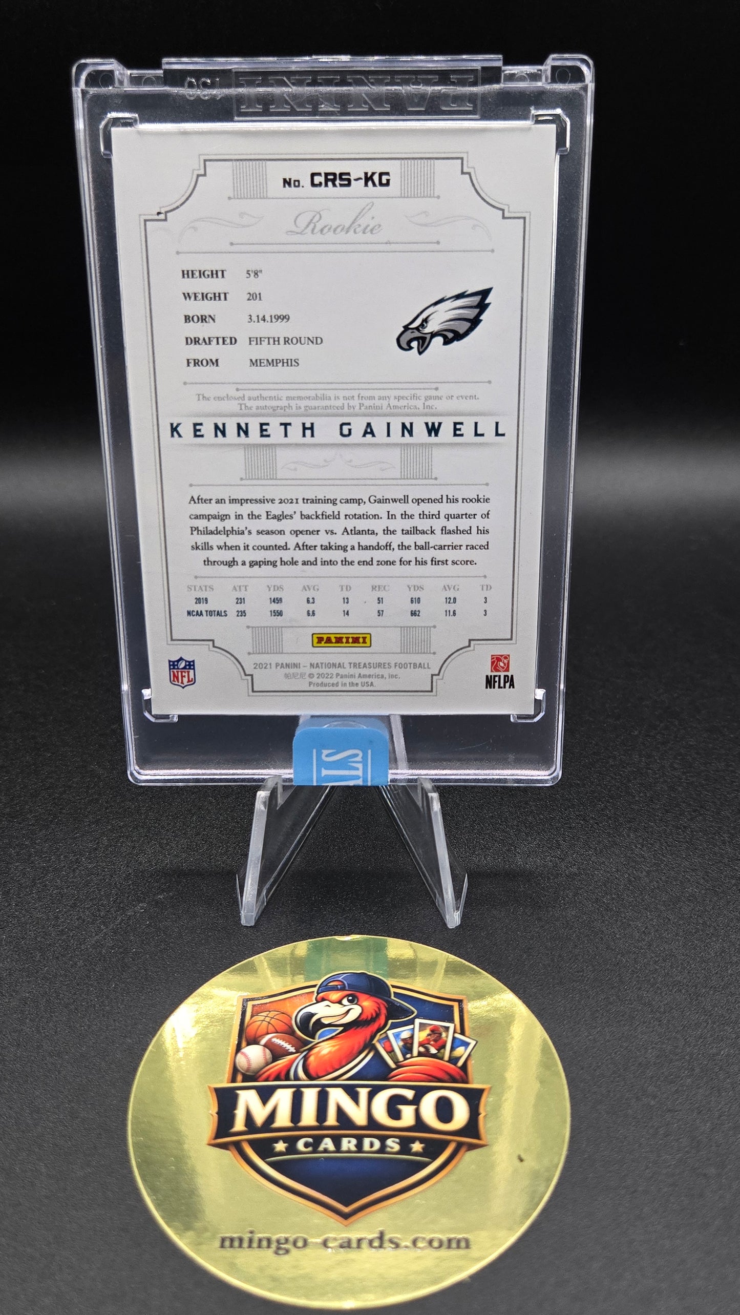 A framed Philadelphia Eagles trading card on a clear display stand, with a gold Mingo Cards logo coin in front on a dark background.