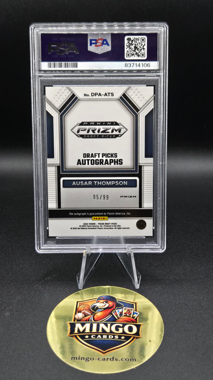 A sealed Panini 2023 Draft Pick Autographs card graded PSA 9, displayed on a black background next to a gold Mingo Cards collectible medallion.