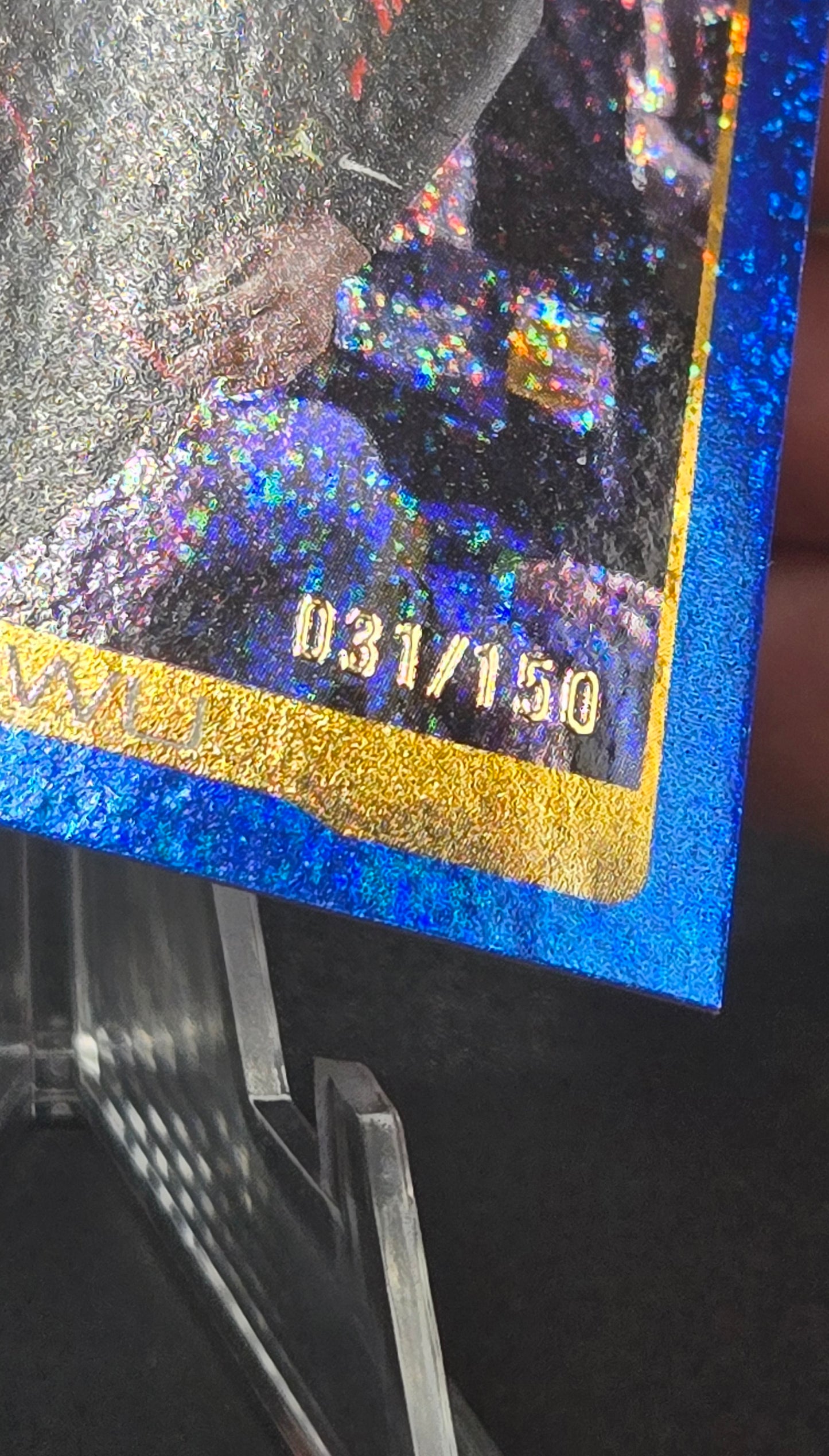 Holographic trading card with metallic blue border and gold text
