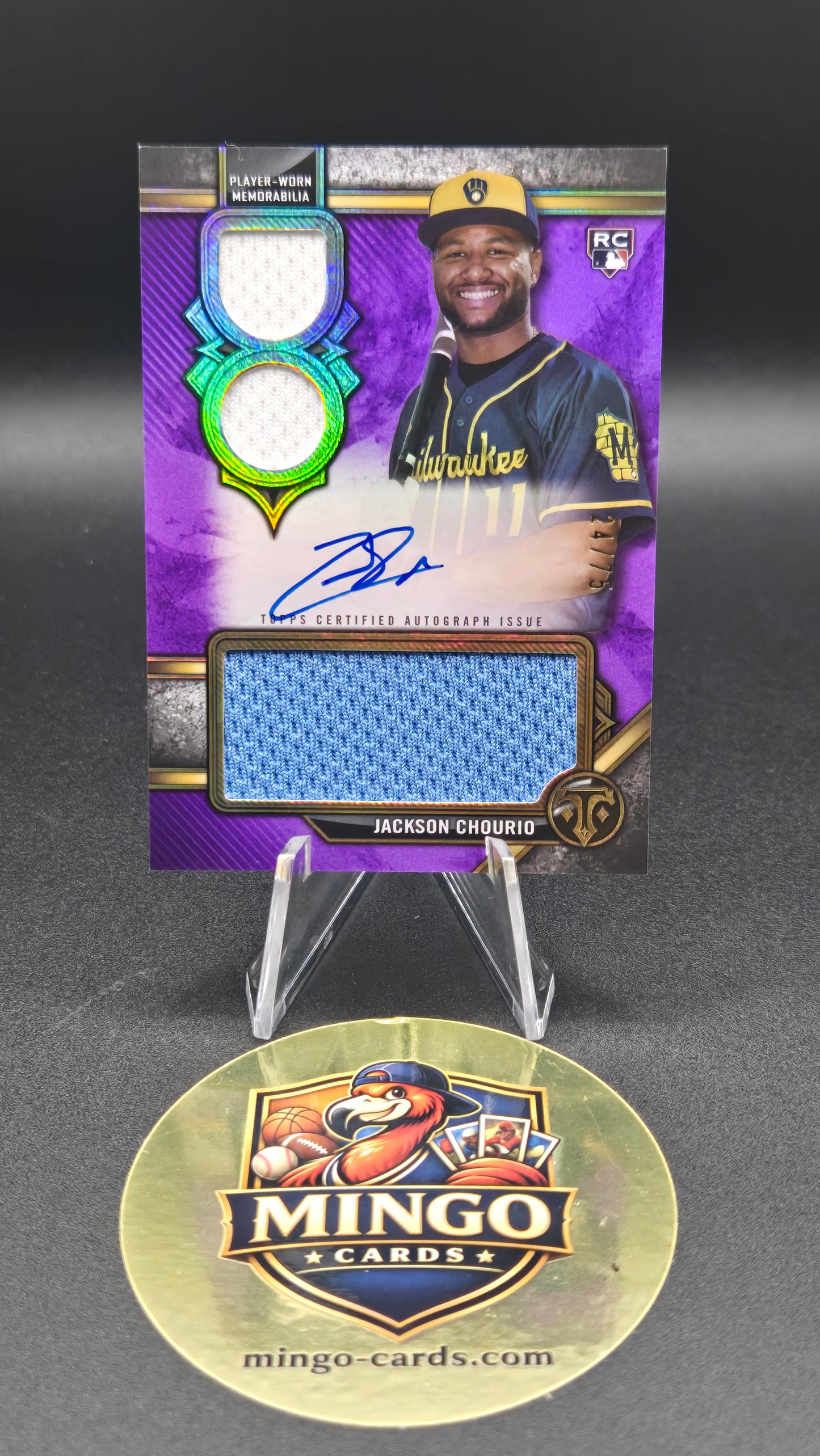 A Mingo Cards baseball trading card featuring Jackson Chourio, shown next to a round gold Mingo Cards display sticker on a dark gray background.