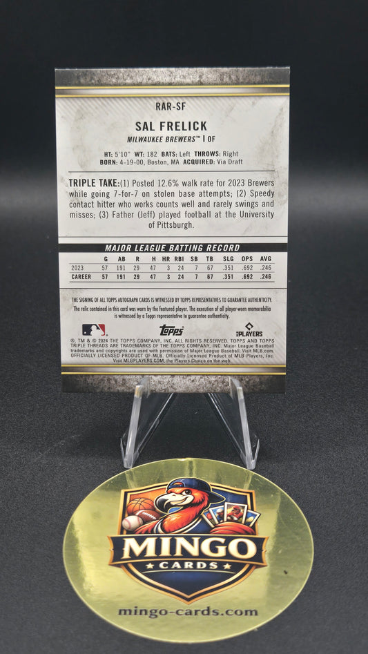 A 2023 Topps Sal Frelick trading card shown with its protective round gold foil cover on a dark background.