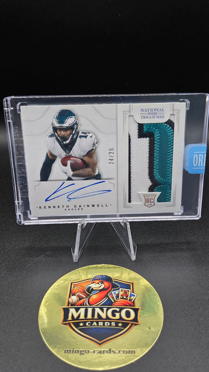 A signed Kenneth Gainwell National Football League trading card in a clear plastic display case, shown next to a gold Mingo Cards promotional medallion on a black background.