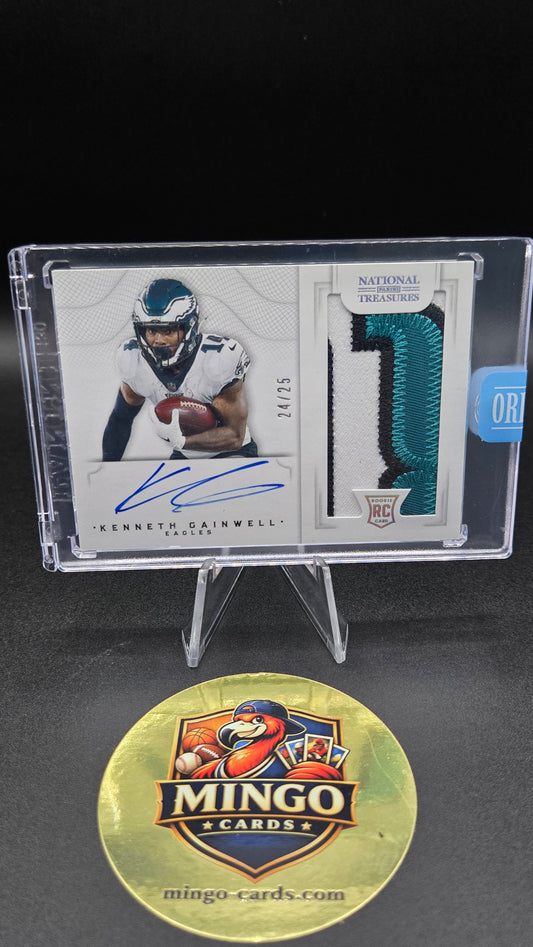 A signed Kenneth Gainwell National Football League trading card in a clear plastic display case, shown next to a gold Mingo Cards promotional medallion on a black background.