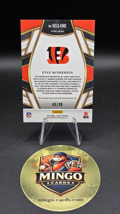 A 2023 Panini NFL trading card featuring Evan McPherson, displayed on a clear stand above a gold Mingo Cards box, against a dark gray background.
