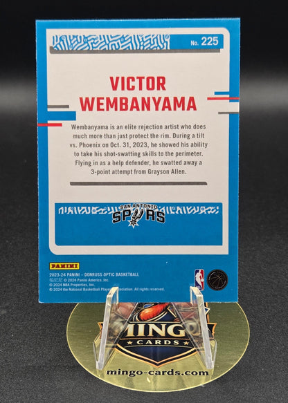 Trading card of Victor Wembanyama with a gold badge on a dark background