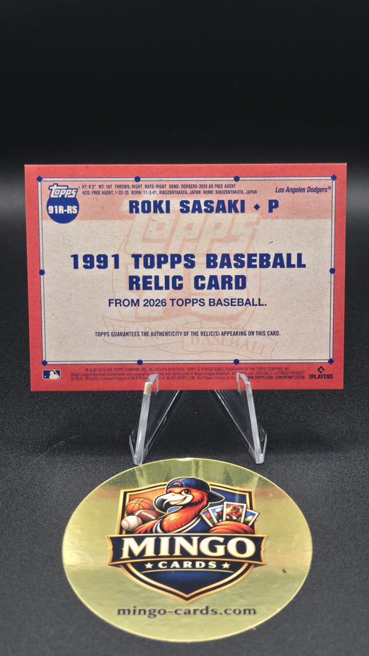 A 1991 Topps baseball relic card featuring Ron Sasaki, displayed on a clear stand next to a round gold Mingo Cards collectible medallion on a black background.